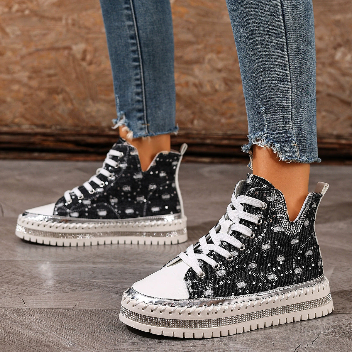 Black lace-up platform sneakers, side view with white laces and textured tread sole