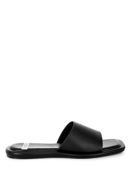 Black square-toe flat slide sandals from side view with padded footbed