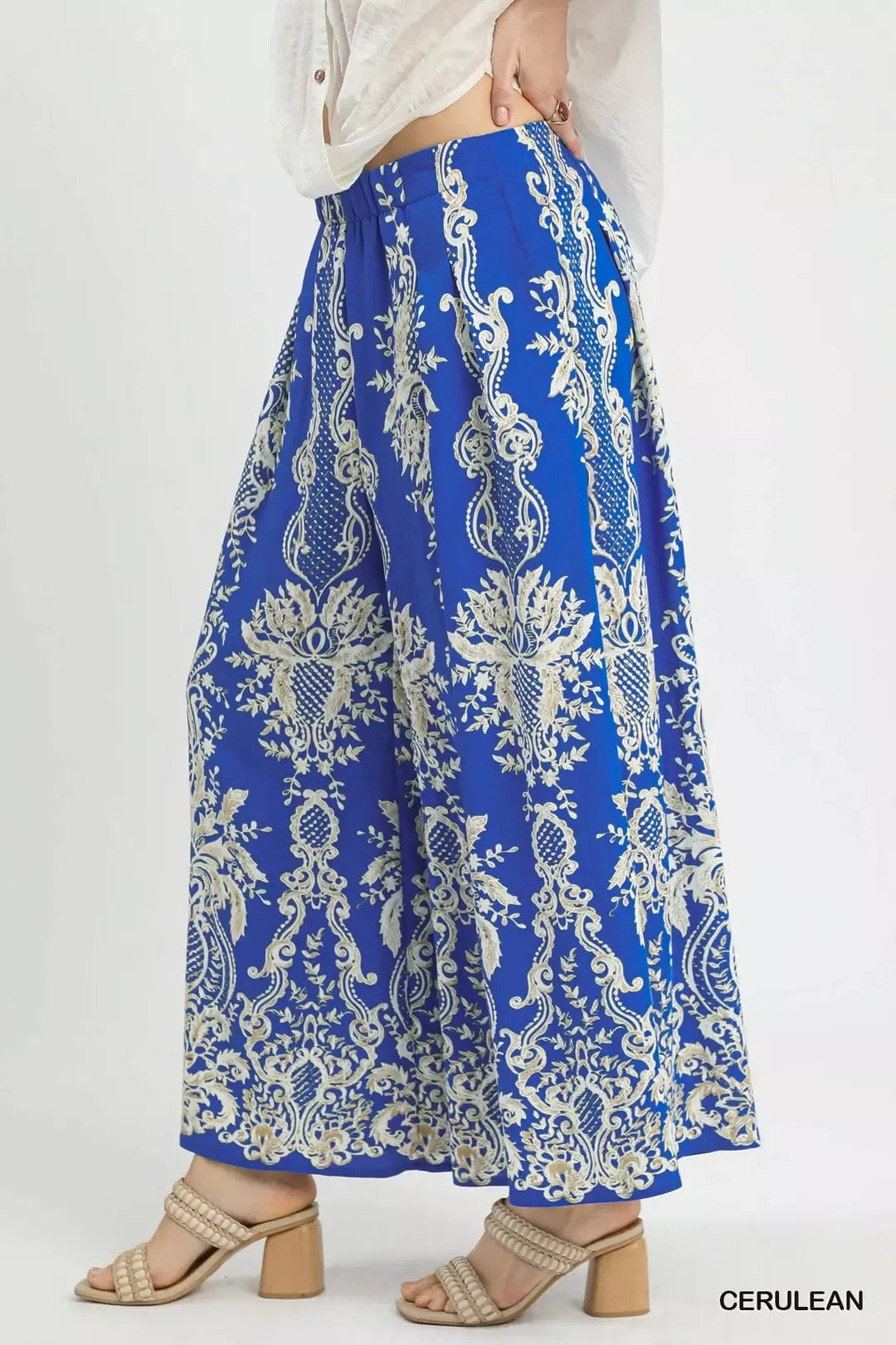 Blue wide-leg pants with allover ornate cream print and flowing drape