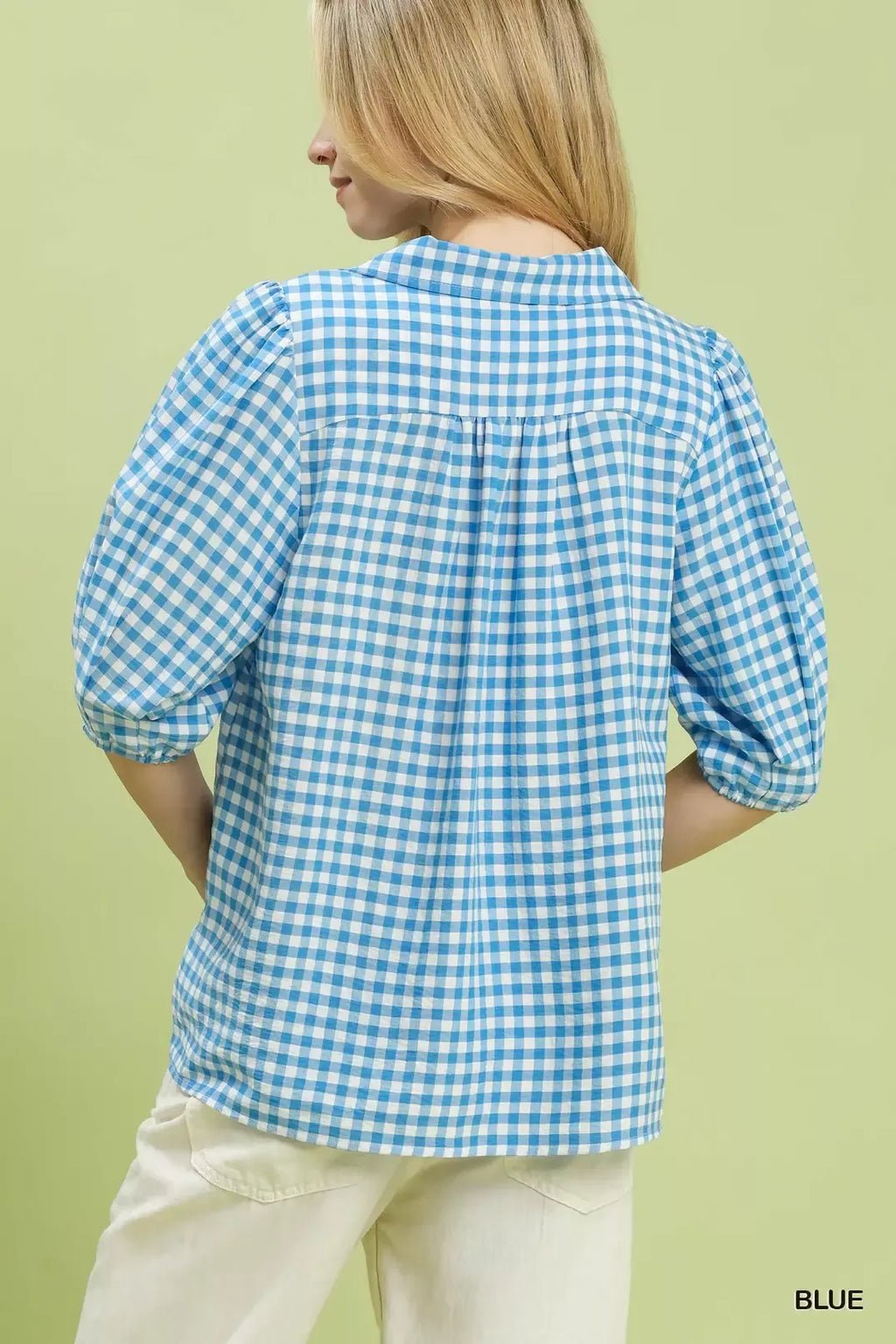 Back view of blue gingham collared blouse with gathered yoke and puff sleeves