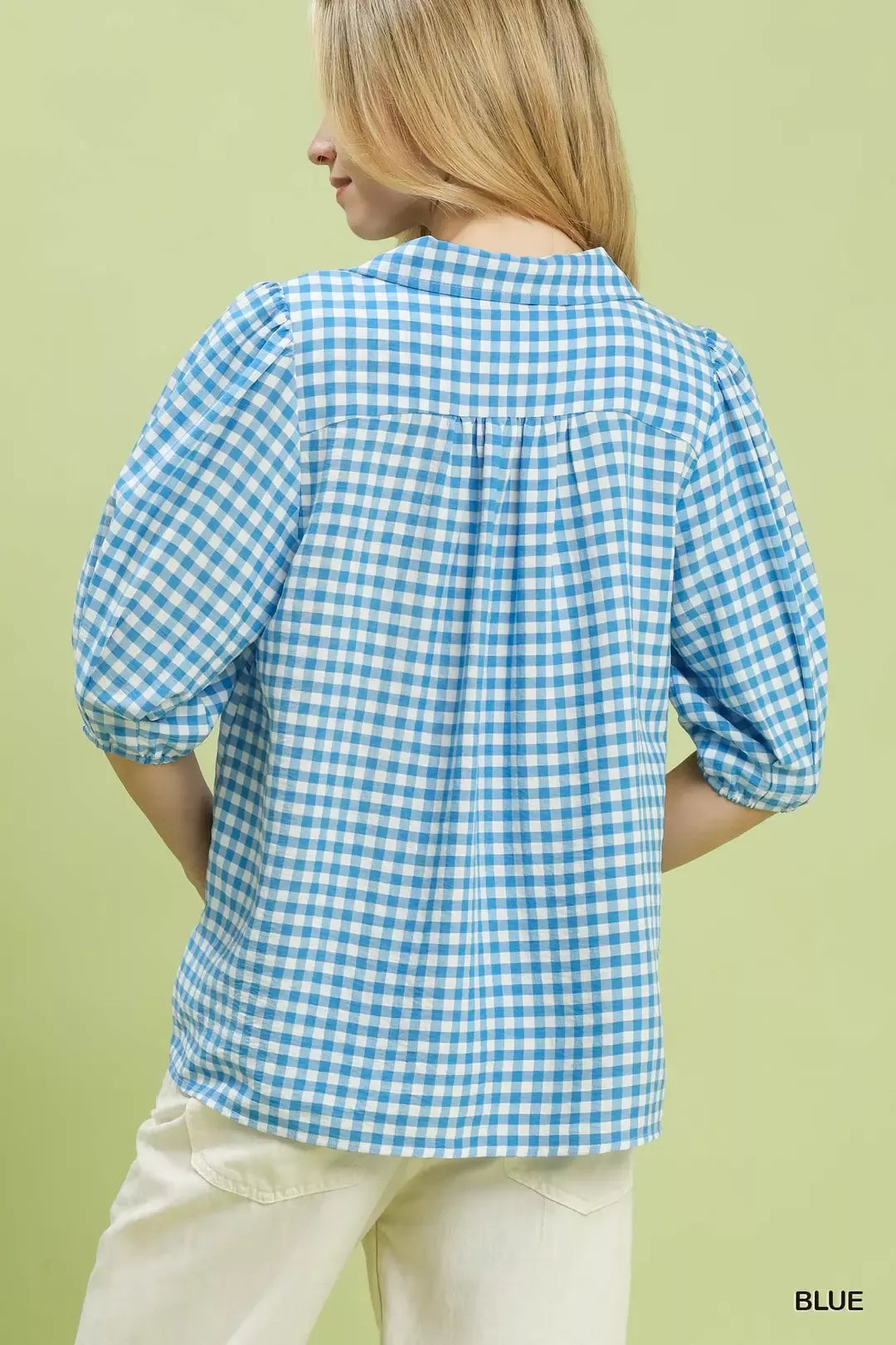 Back view of blue gingham collared blouse with gathered yoke and puff sleeves