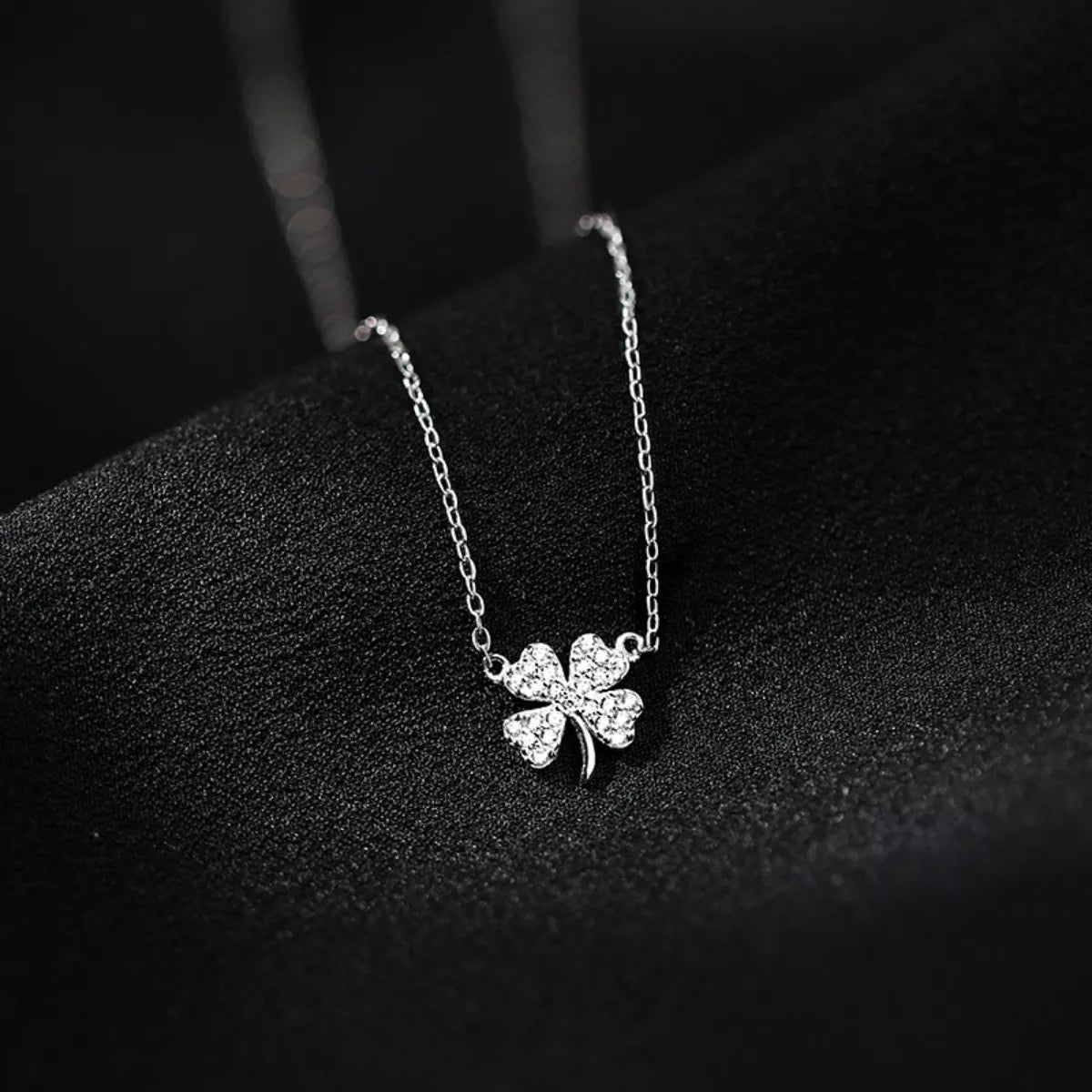 Sterling silver four-leaf clover necklace pendant with zircon accents on chain
