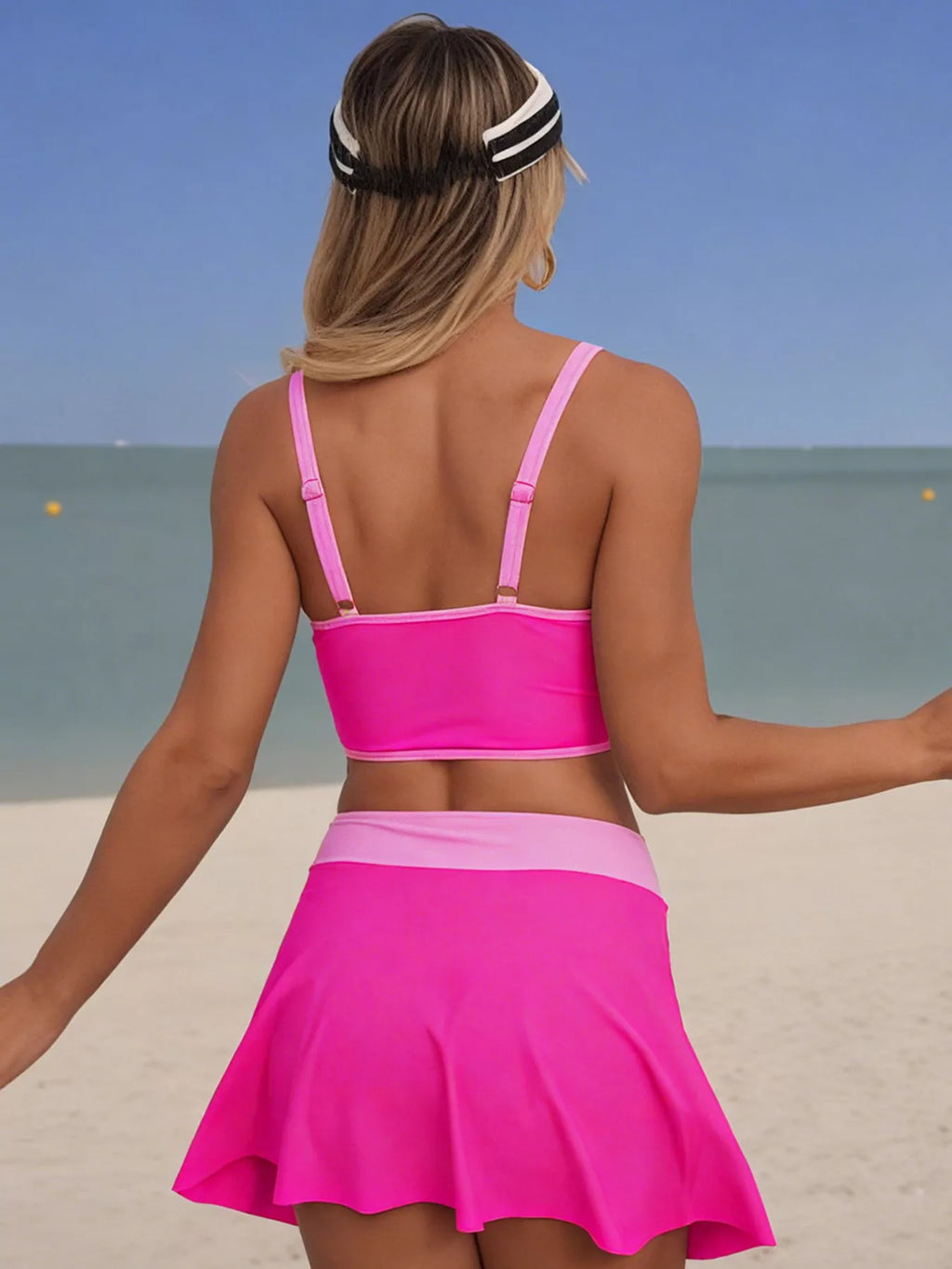 Back view of fuchsia pink swim set with adjustable straps and tiered skirt