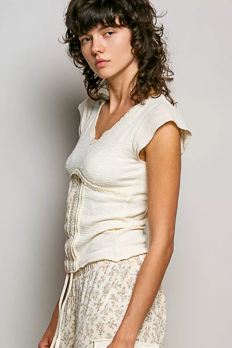Cream lightweight textured knit V-neck top with lace trim, side view