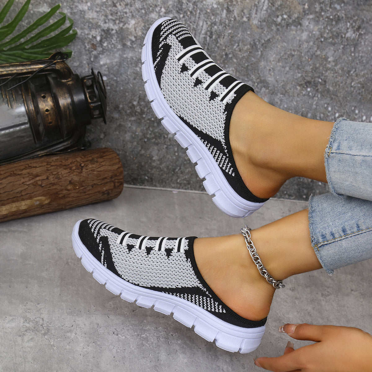 Breathable knit slip-on sneakers, black with white stripe pattern and white sole