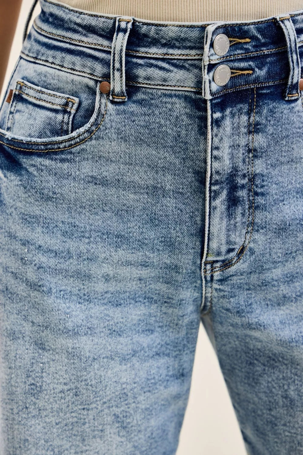 Light Blue denim waistband close-up with button closure and belt loops