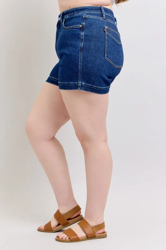 Dark blue denim shorts, side view with back pocket detail
