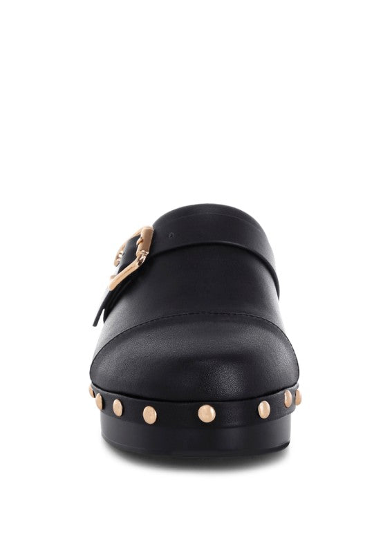 Black leather clog with round toe, buckle strap, and studded front edge