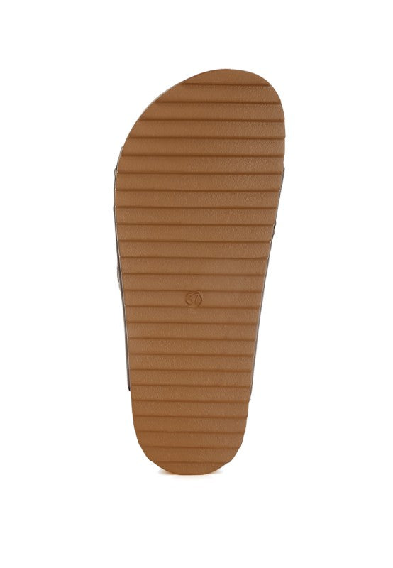 Tan sandal outsole with ribbed tread on a flatform base