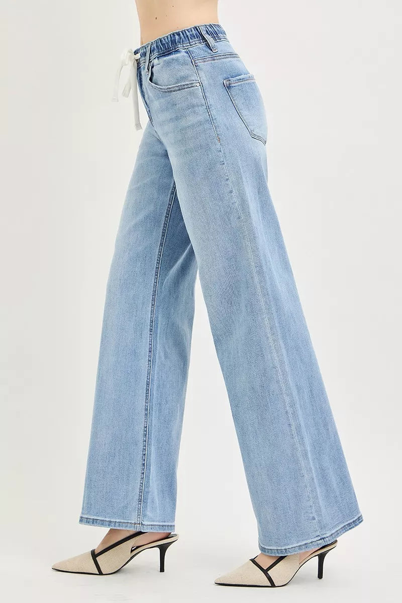 Light-wash wide-leg jeans, side view with elastic waist and back slant pockets