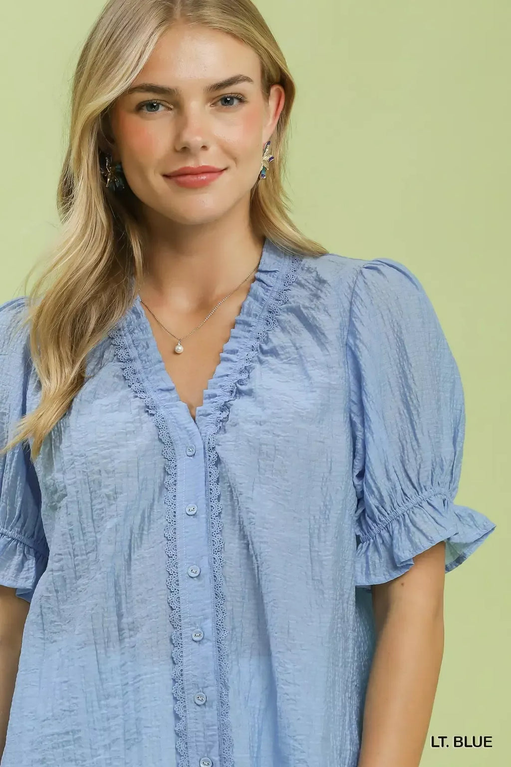 Light blue textured button-front blouse with V-neck and gathered puff sleeves