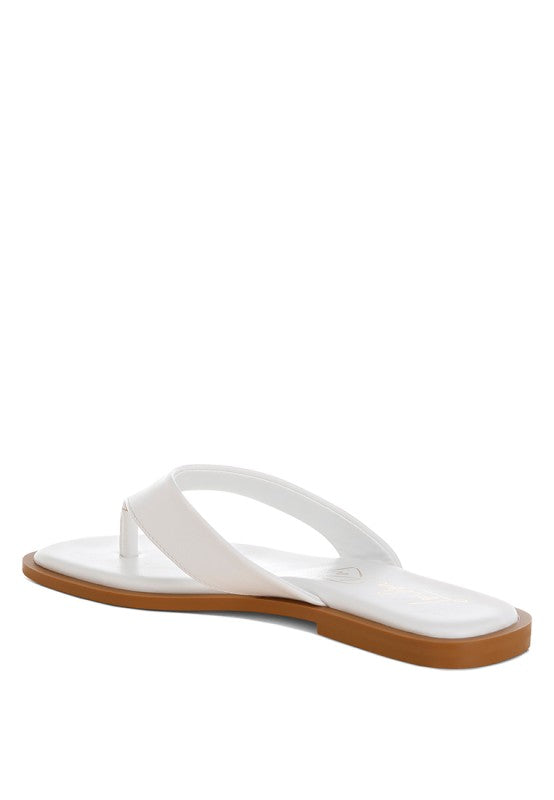 White toe-post thong flats from side angle, square toe opening and flat sole