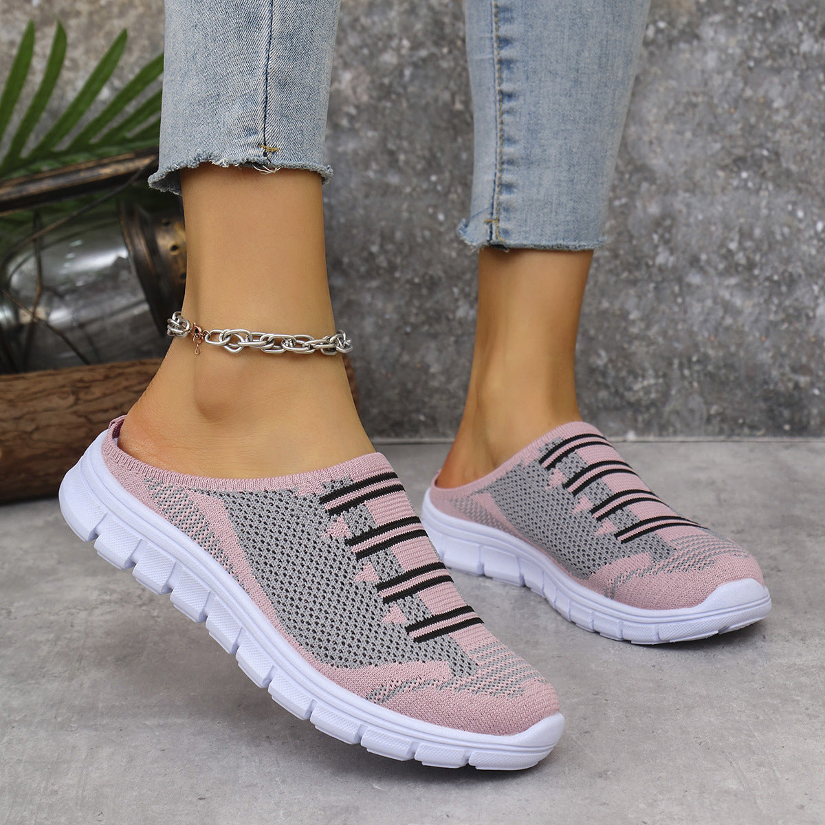 Pink/gray knit slip-on sneakers with black stripe pattern and white tread sole
