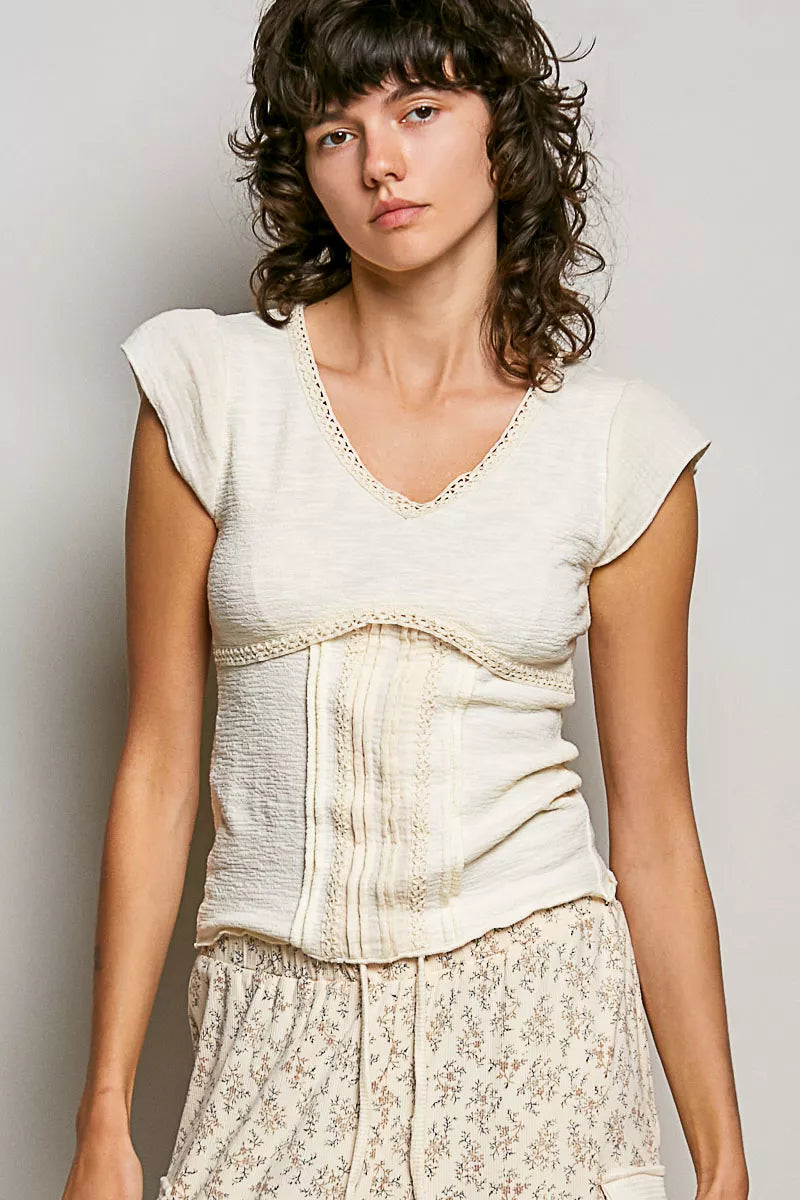 Lightweight cream V-neck knit top with lace trim and textured short sleeves