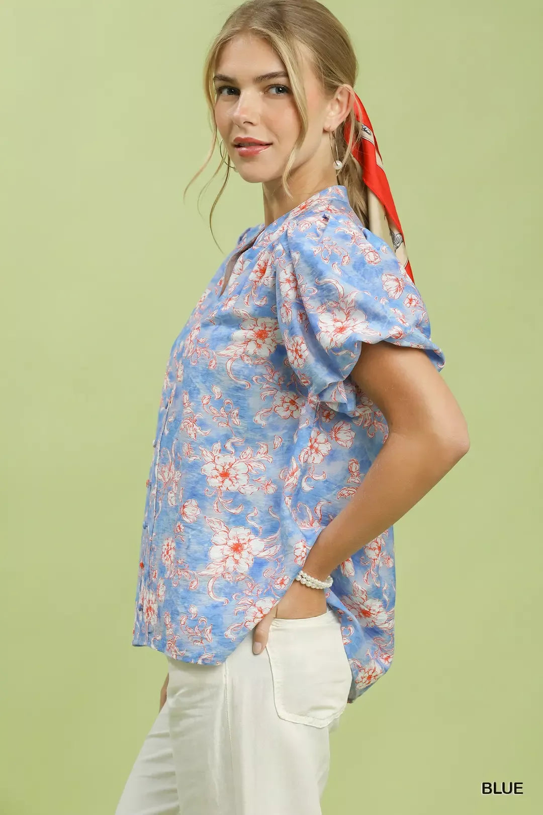 Blue floral short-sleeve shirt with V-neck and billowy sleeves, side view
