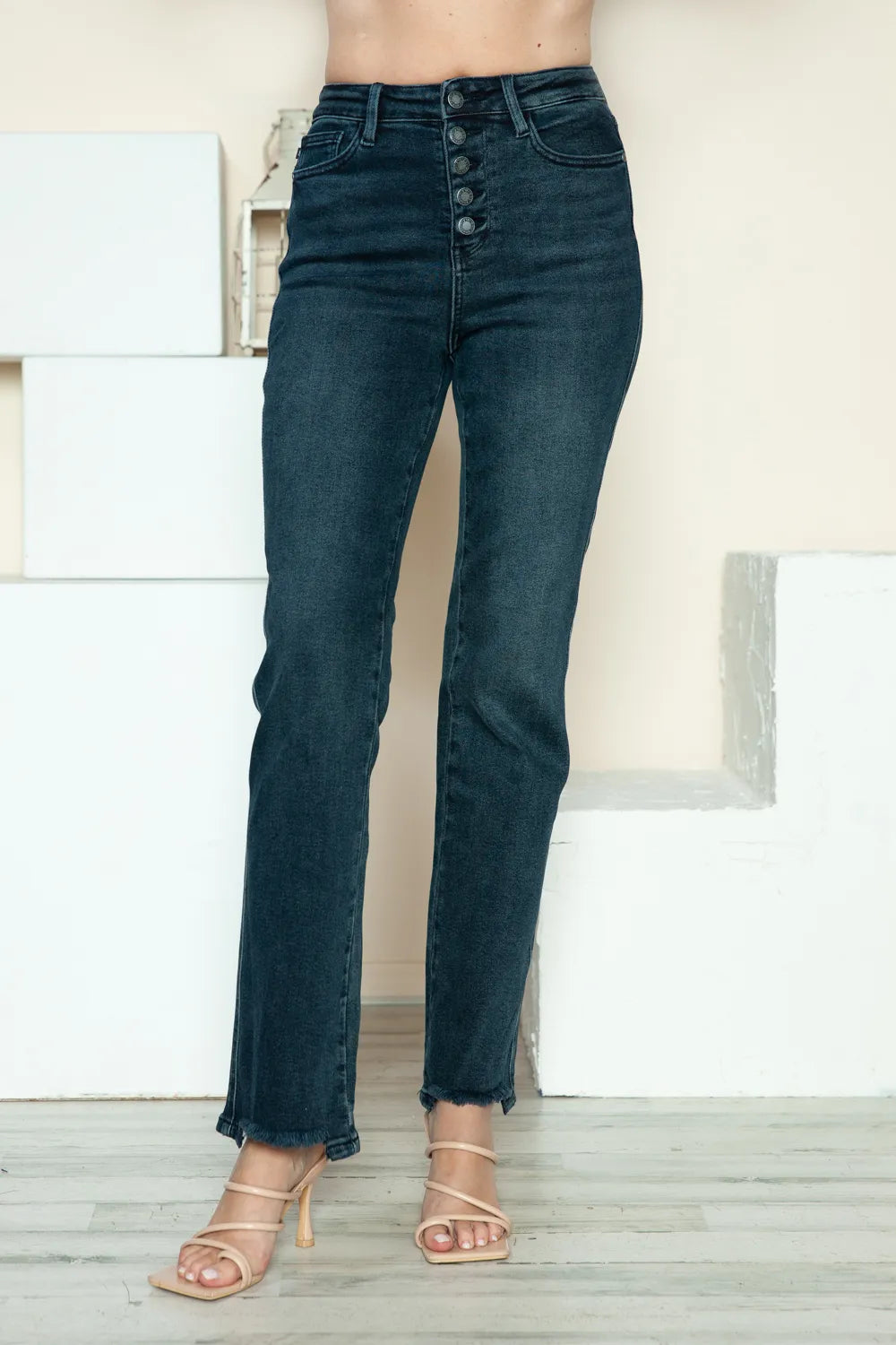 Dark blue straight jeans, button-fly detail and frayed raw hem