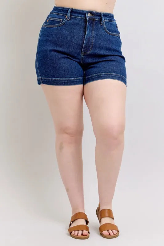 Dark blue high-waist tummy-control denim shorts, front view with button and belt loops