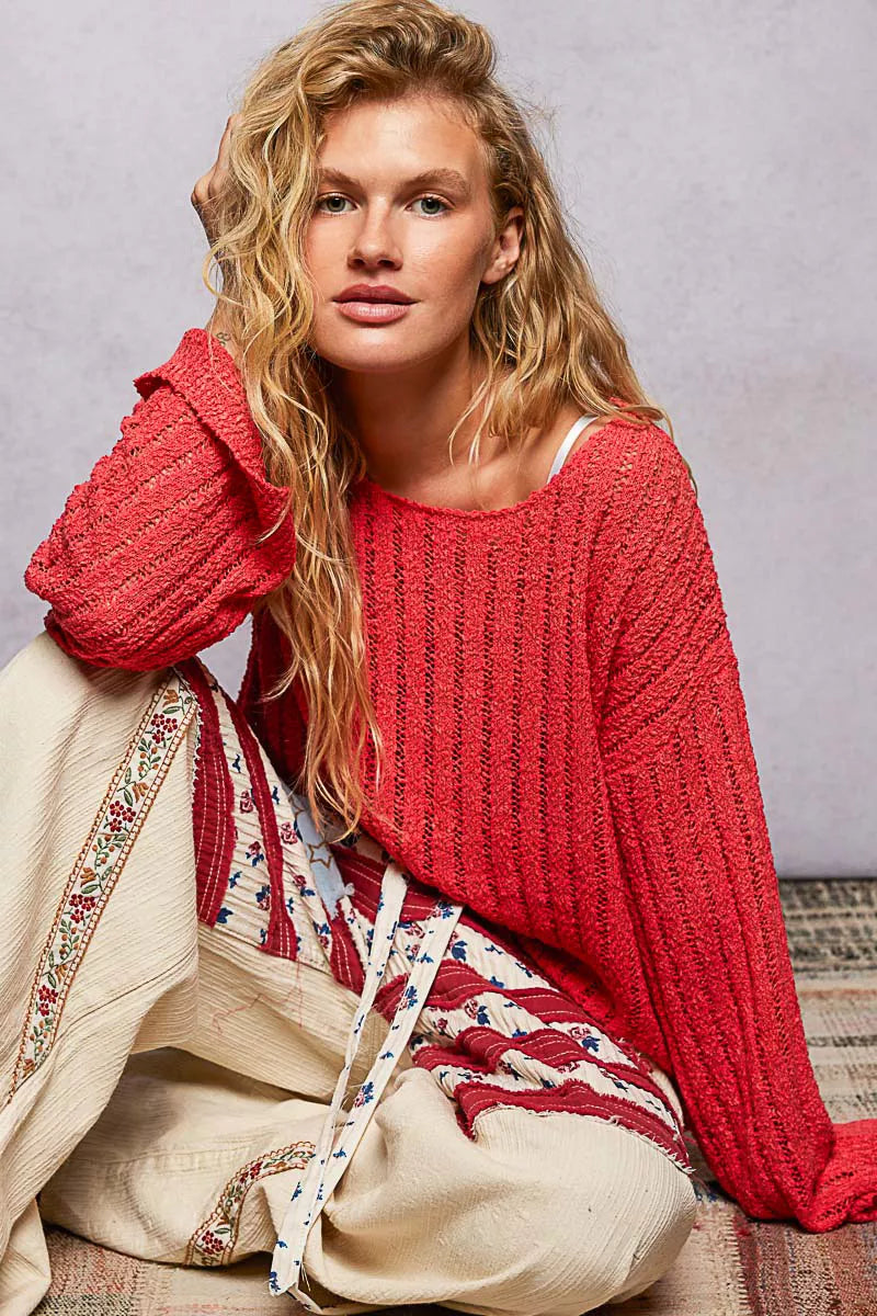 Red open-weave sweater with round neckline and long sleeves, relaxed fit