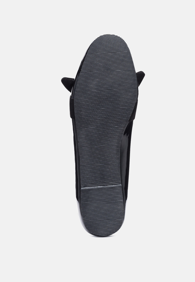 Black loafer sole view with ribbed outsole and bow detail