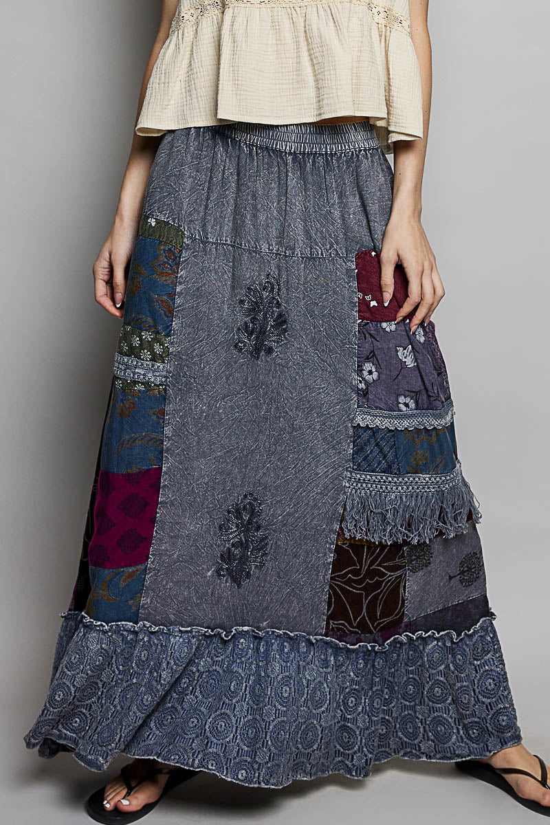 Charcoal Multi patchwork skirt with embroidered details, ruffled hem, and fringe trim