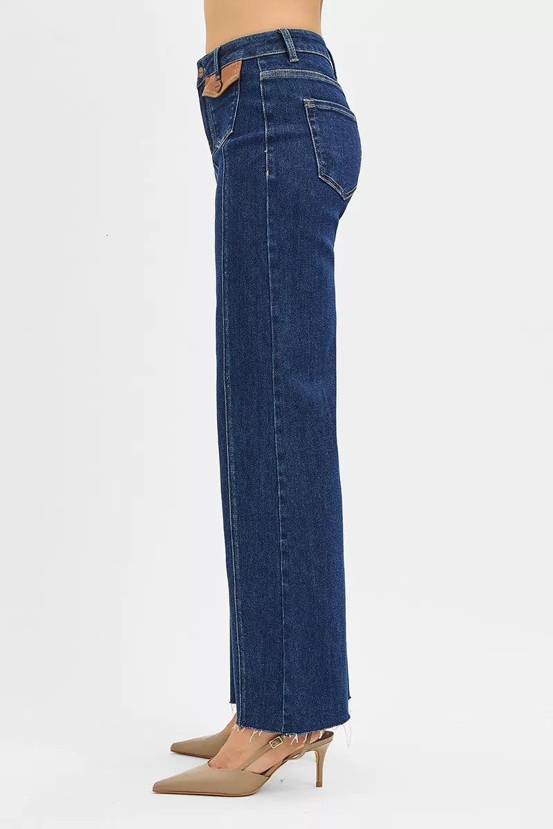 High-rise wide-leg jeans in dark denim with angled side pockets and vented hem
