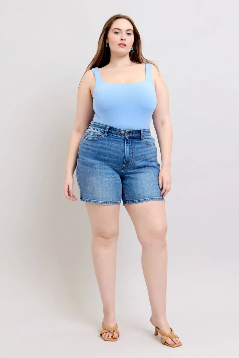 Medium wash denim shorts, front view; roomy plus-size fit and front pockets