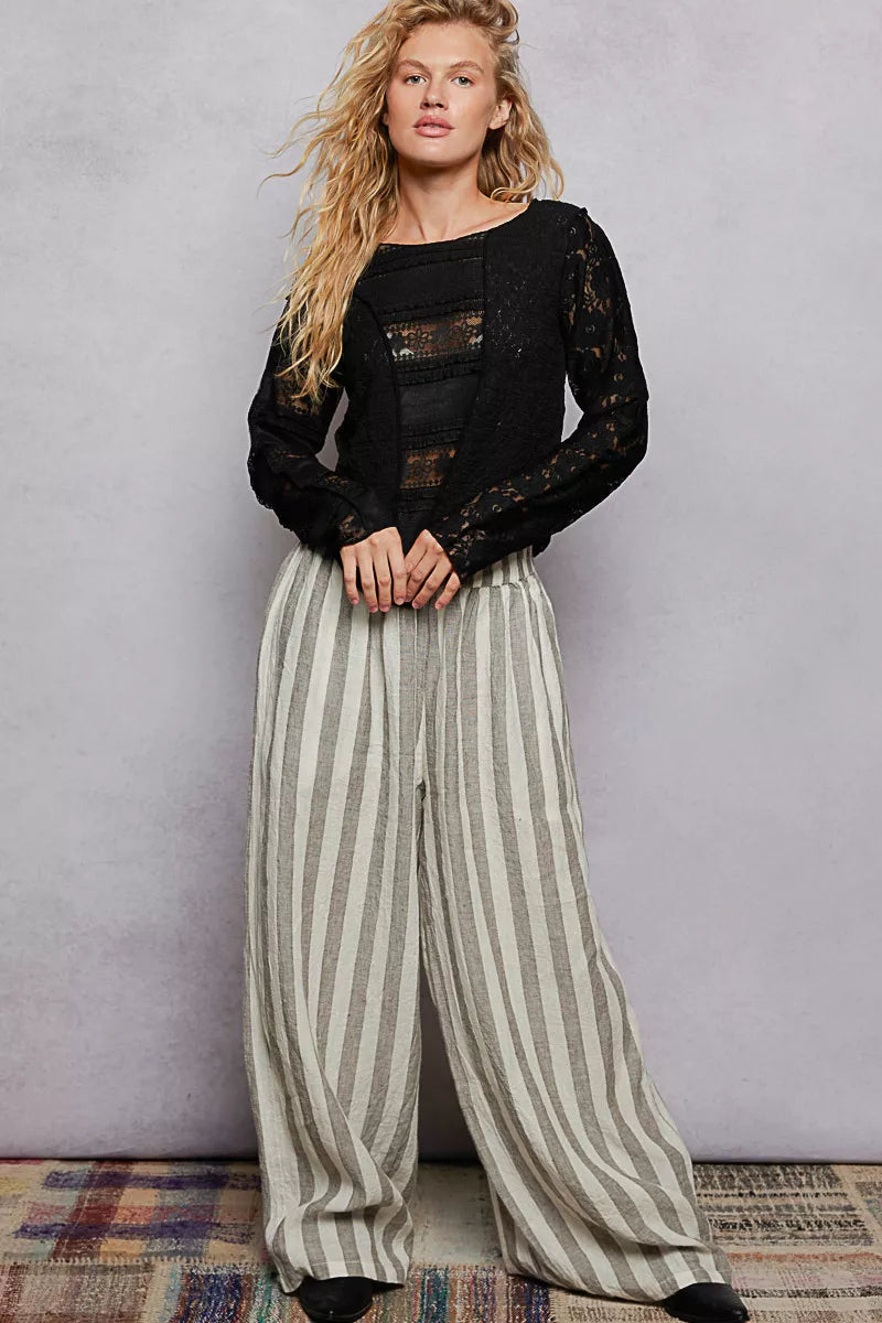 Black long-sleeve round-neck top with exposed seams and lace detailing
