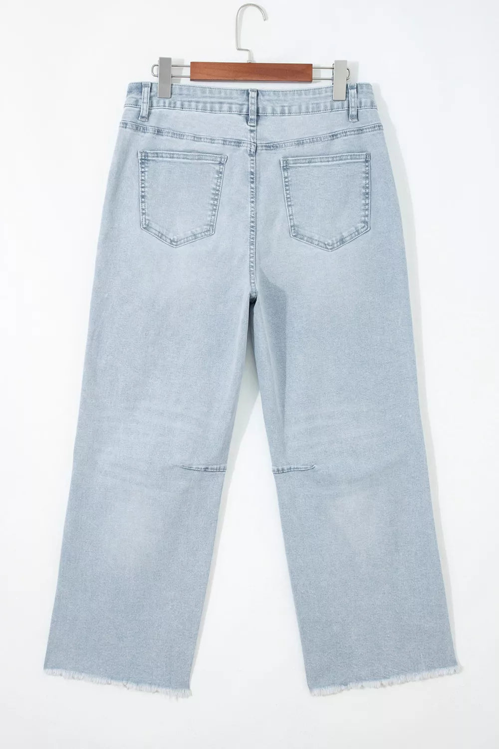 Light wash straight-leg jeans on hanger, light blue denim with front pocket detailing