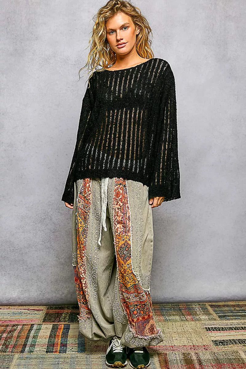 Black open-weave long-sleeve sweater with round neck and loose silhouette
