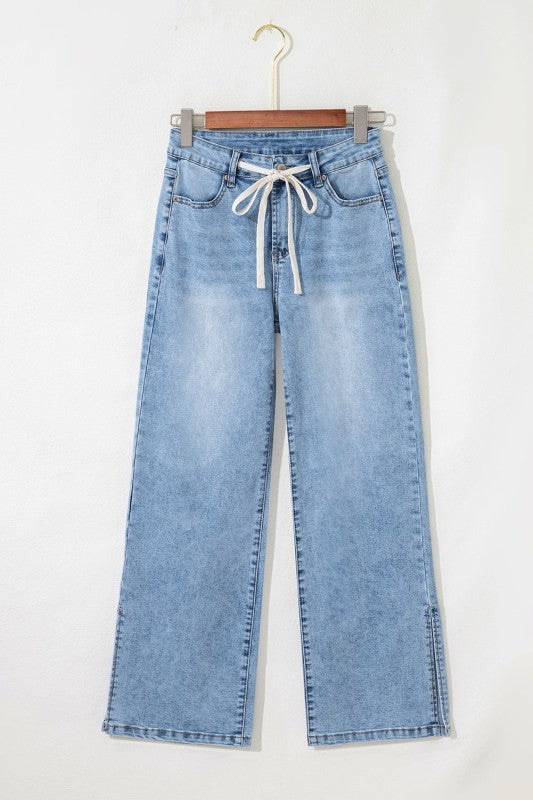 Light blue wide-leg jeans on hanger, front drawstring tie and five-pocket style.