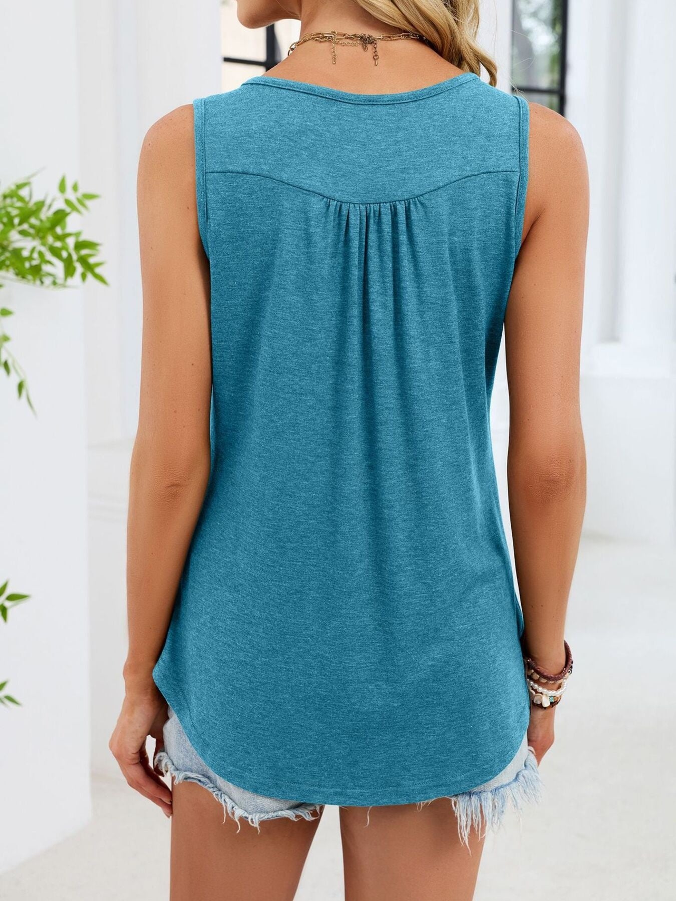 Back view button-detail round neck tank in blue-green, sleeveless with draped back