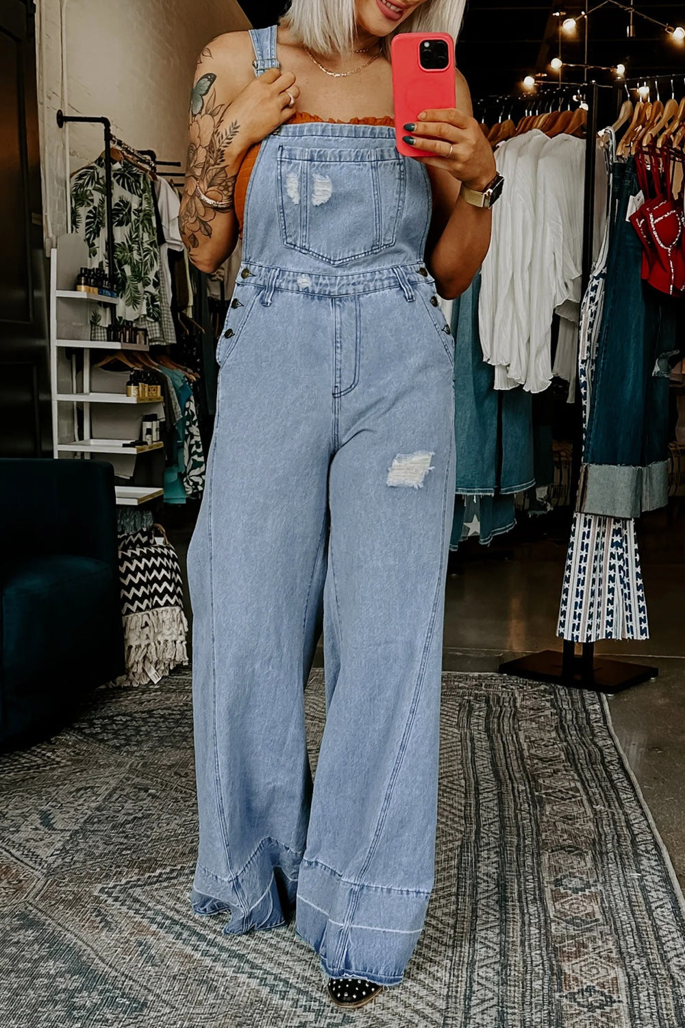 Light blue distressed wide-leg denim overalls, front bib with chest pocket