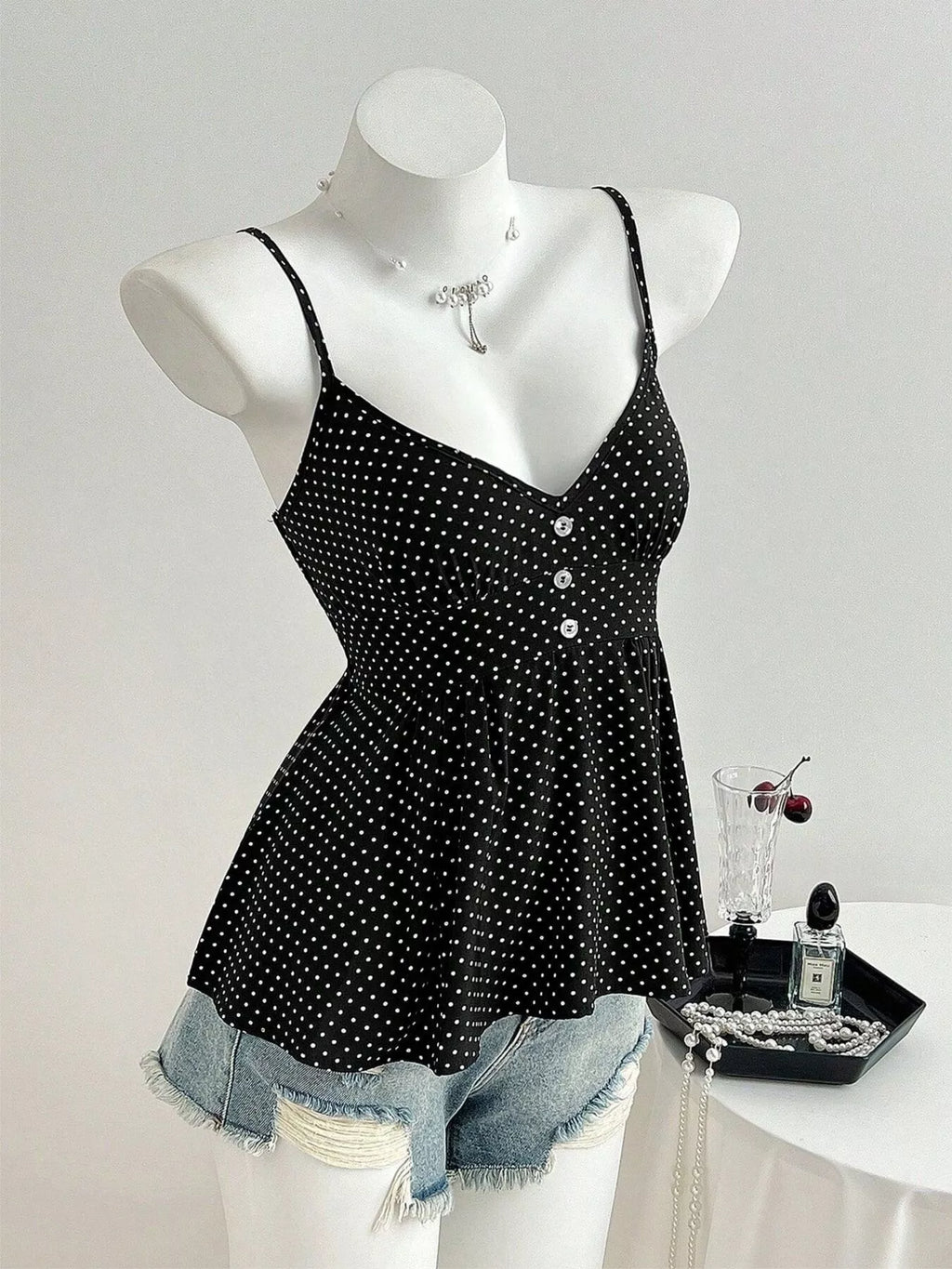 Black polka dot V-neck cami with gathered skirt and button detail