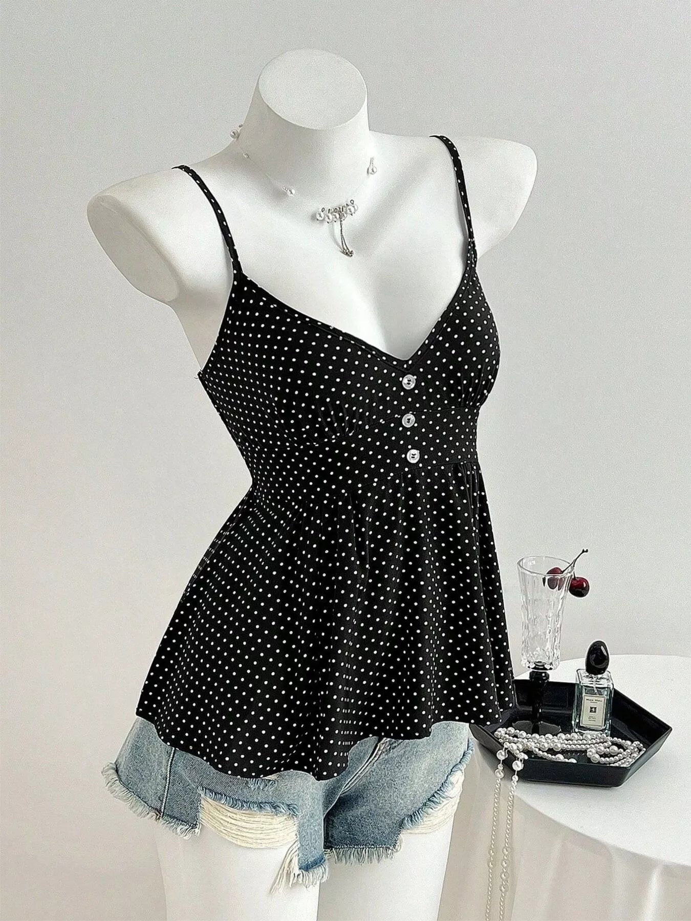 Black polka dot V-neck cami with gathered skirt and button detail