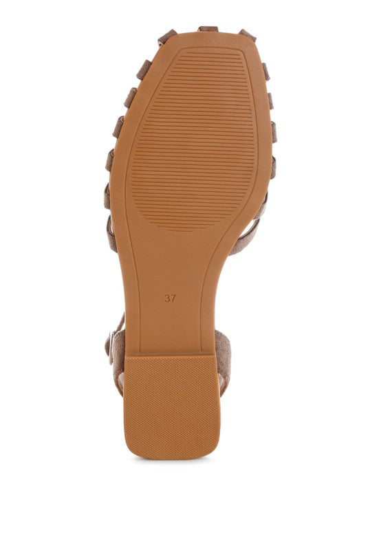Taupe flat sandal heel view with ankle strap and rubber sole tread