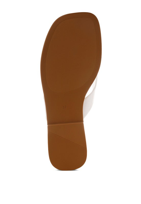 Tan/bronze thong flats outsole and heel, showing full bottom profile