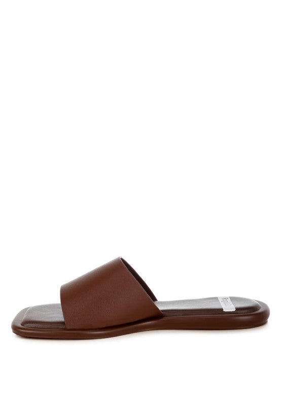 Brown square-toe flat slide sandals from side angle with open toe design