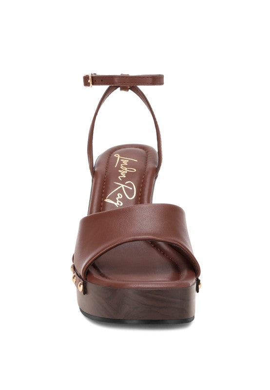 Brown sandal with platform sole on a white background