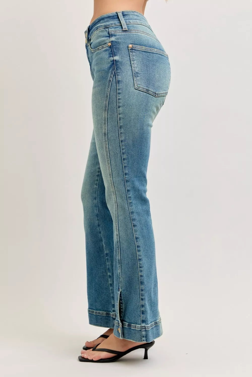 Back view: high-waist flare jeans in light blue vintage-wash denim