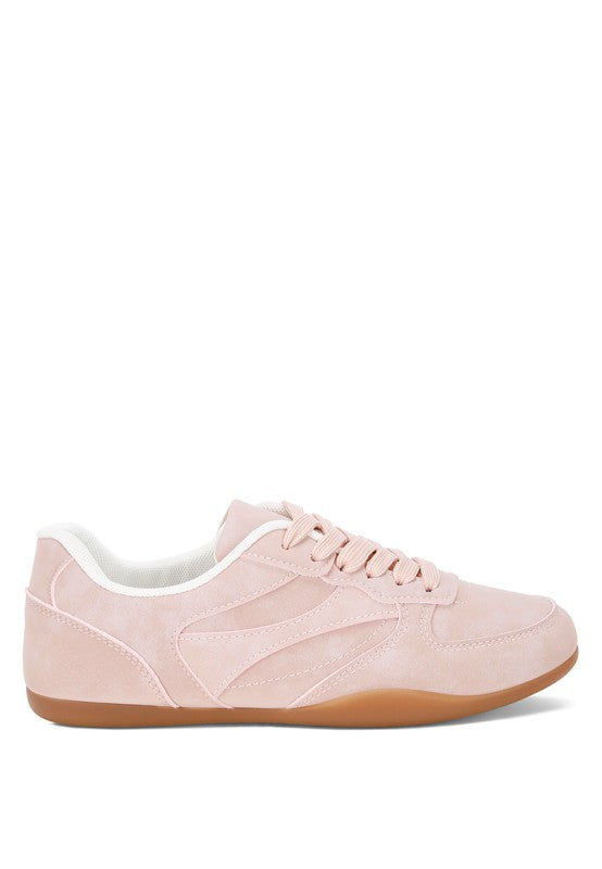 Side view of blush-pink lace-up sneakers with paneling detail and gum sole