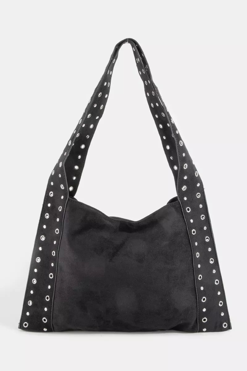 Suede grommet strap shoulder bag in black with silver eyelet trim