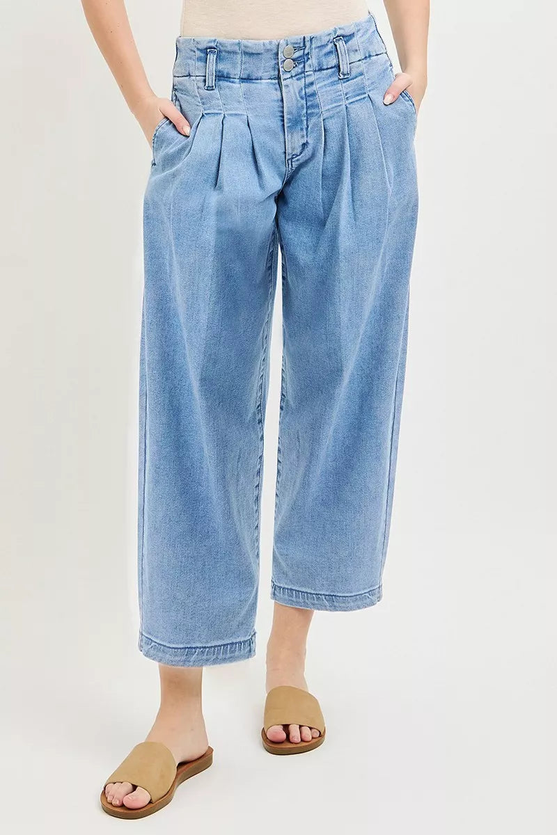 Medium-blue slouchy crop barrel jeans, side view with pleats and front pockets