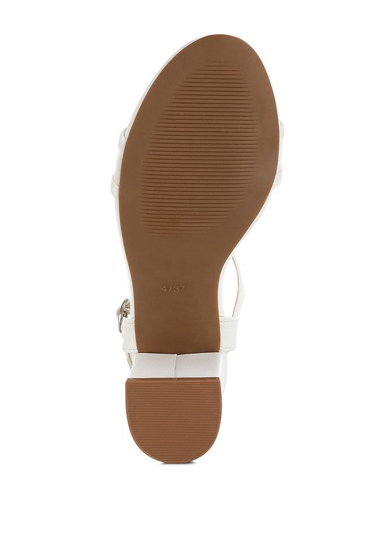 White block-heel sandal outsole with visible pin-buckle hardware