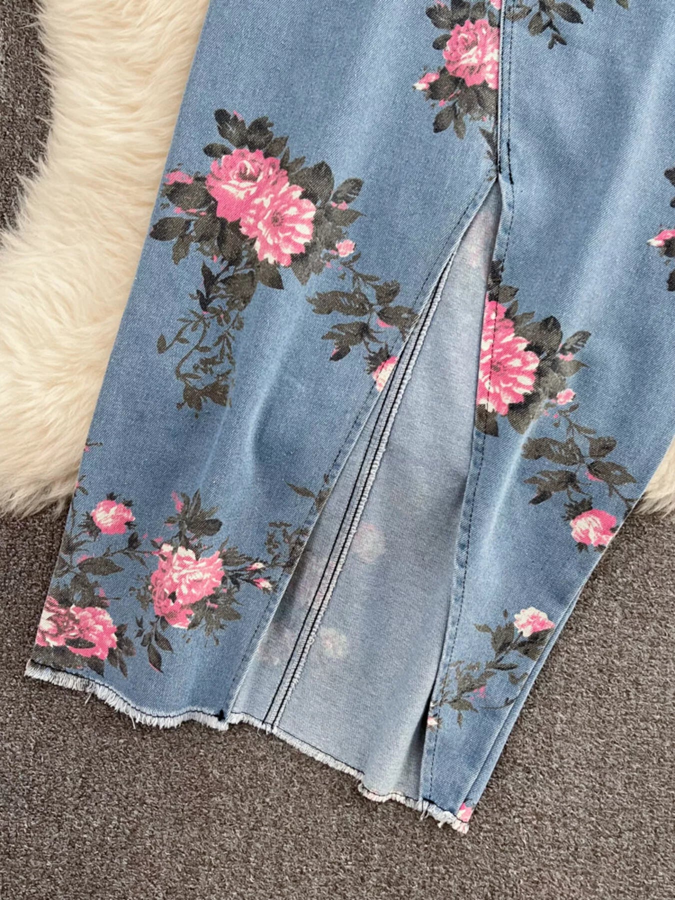 Blue denim skirt with pink floral side panels and front seam slit