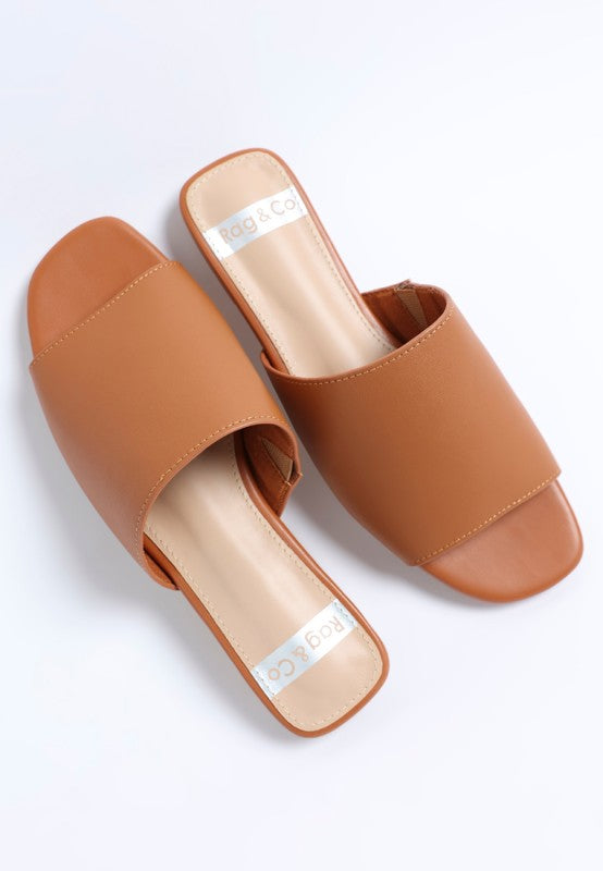 Tan leather slip-on flats, open toe, wide strap across the front