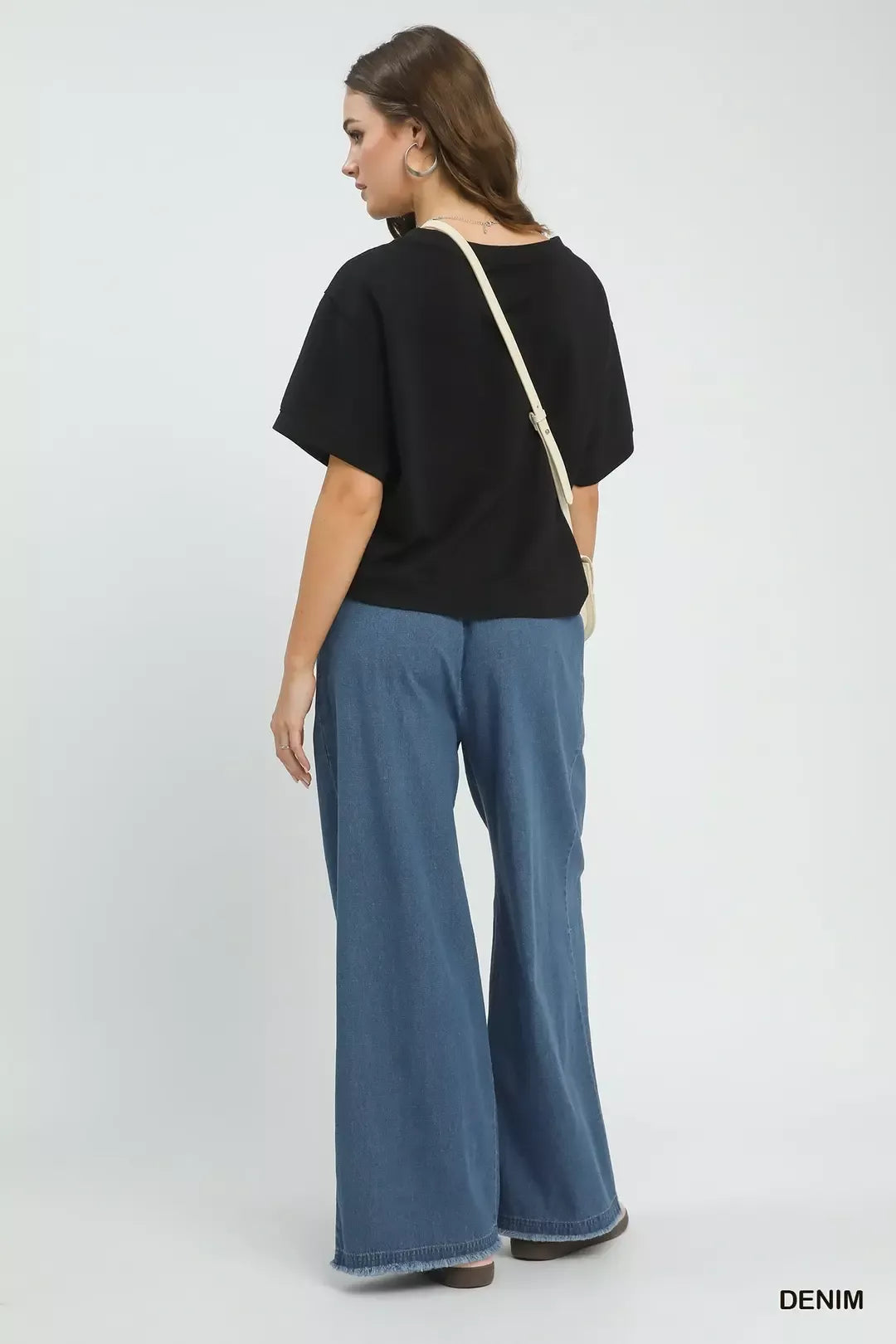 Back view: stone-washed wide-leg denim pants with elastic waist