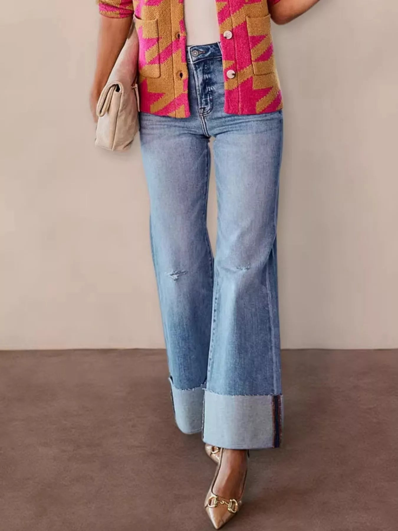 Blue high-waisted flare jeans with distressed front and cuffed wide hem