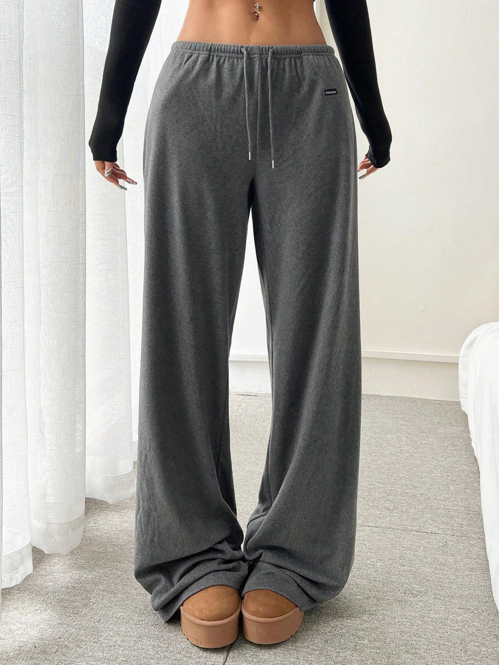 Gray relaxed fit drawstring pants with elastic waist and side seam pockets