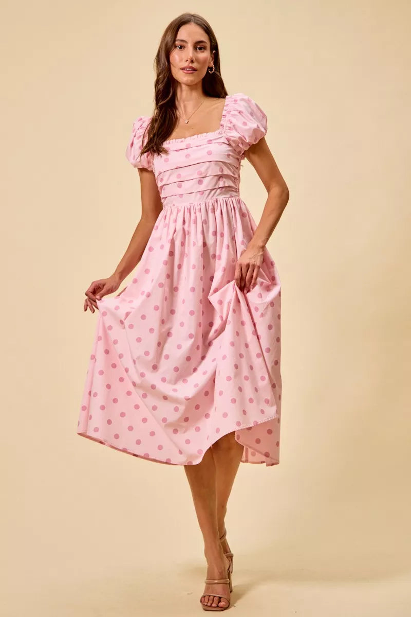 Pink polka-dot midi dress with tiered gathered skirt and short puff sleeves