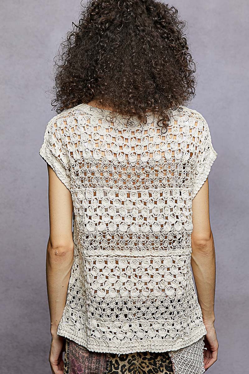 Back view of natural openwork crochet top with cap sleeves and scalloped trim